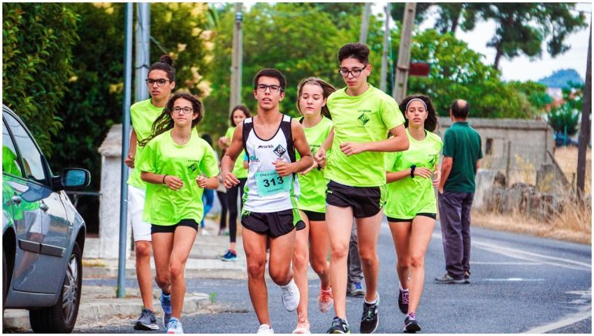 A group of young joggers running together on a roa