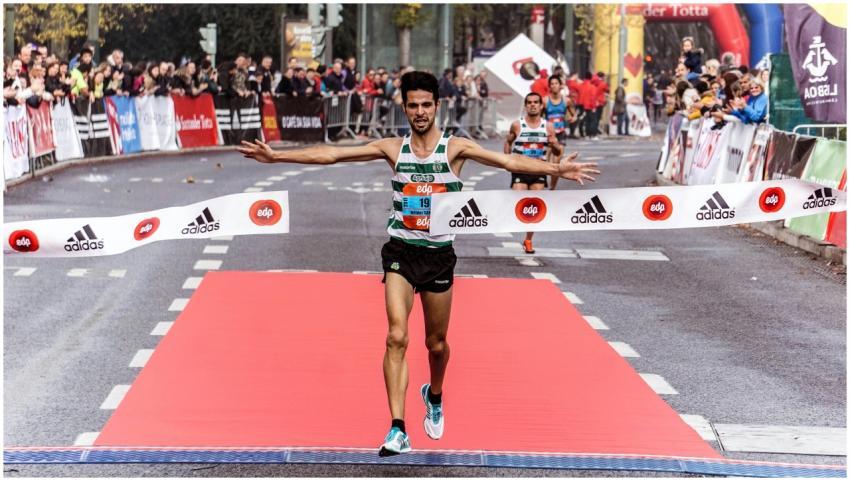 A triumphant marathon winner crosses the finish li