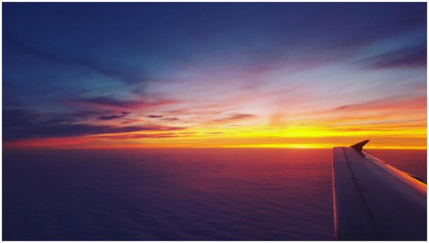 A breathtaking view of an airplane wing against a