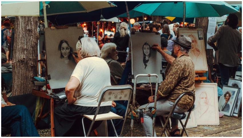 Street artists capture portraits in a lively outdo