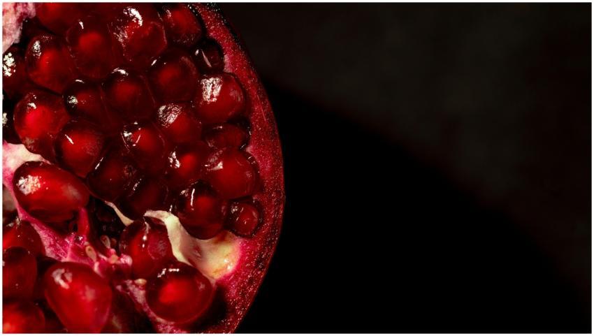 Vibrant close-up of ripe, juicy pomegranate seeds,