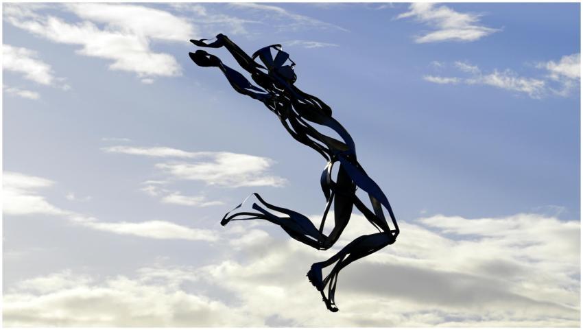 Artistic metal sculpture of a jumping figure set a