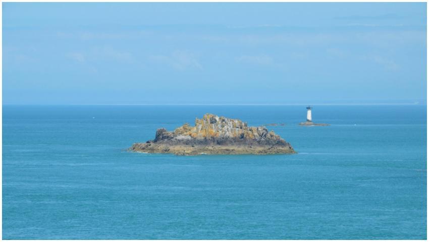 Beautiful view of a rock island and distant lighth