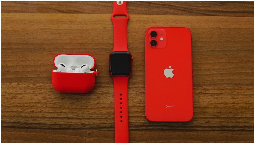 Top view flat lay of red apple watch, iPhone, and