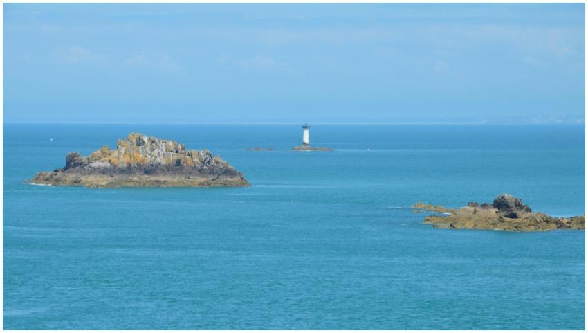 Tranquil ocean view featuring rocky islets and a l