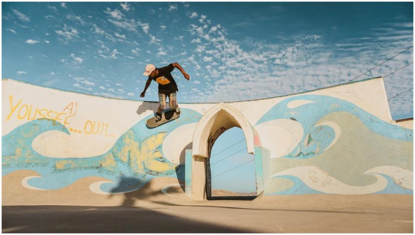 Young man skateboarding at an outdoor park in Tagh