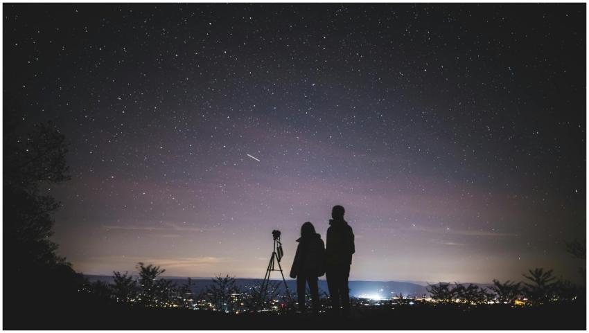 A couple stargazes under a starry sky in Elkton, V