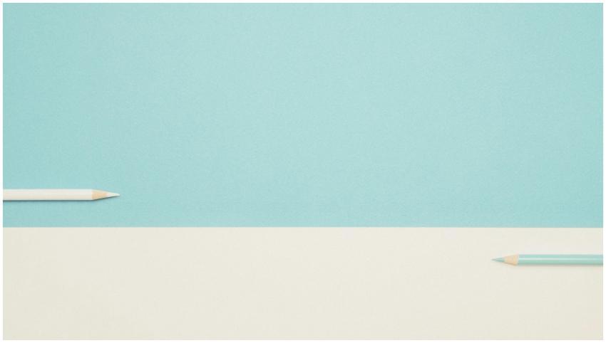 Two colored pencils on a minimalist blue and white
