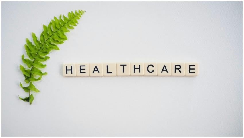 Healthcare word spelled with Scrabble tiles next t