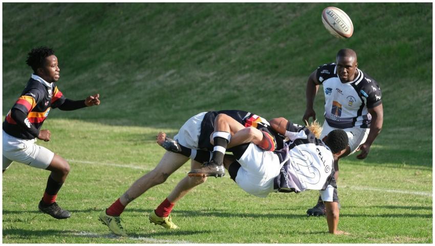 Dynamic rugby scene depicting players tackling and