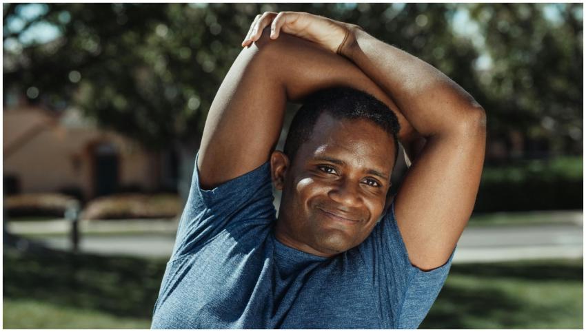 A man enjoying a stretching exercise outdoors with
