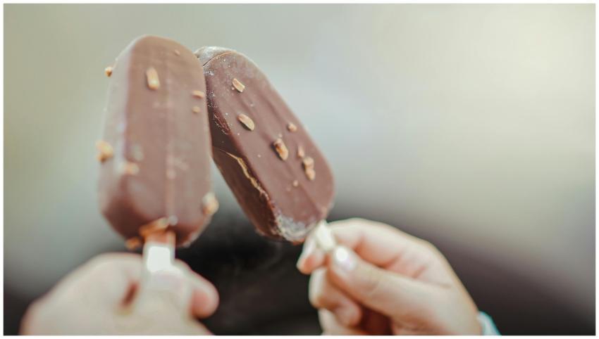 Close-up of two chocolate ice cream bars with nuts