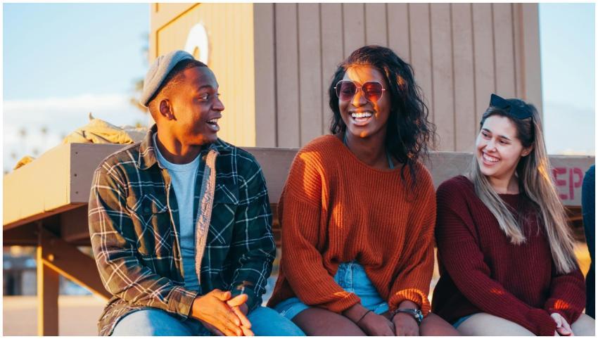 A joyful group of friends laughing together near a