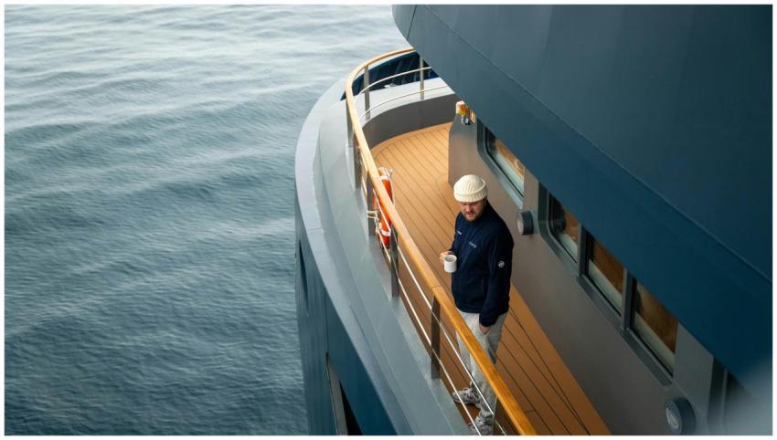 Man enjoys coffee on yacht deck overlooking the se