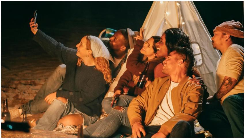 A group of friends joyfully taking a selfie at a n