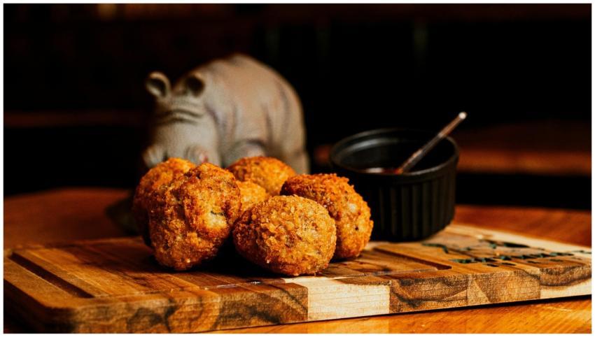 Crispy homemade croquettes served on a wooden boar