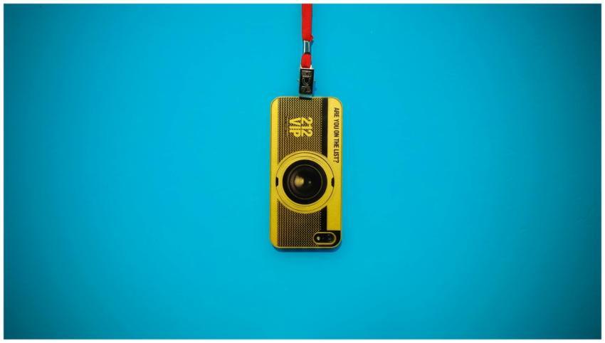 A vibrant yellow camera keychain with lanyard set