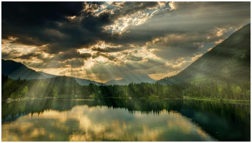 A stunning view of a tranquil lake surrounded by m