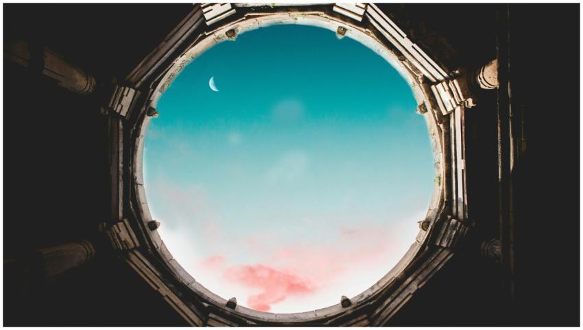 Majestic crescent moon visible through an ancient