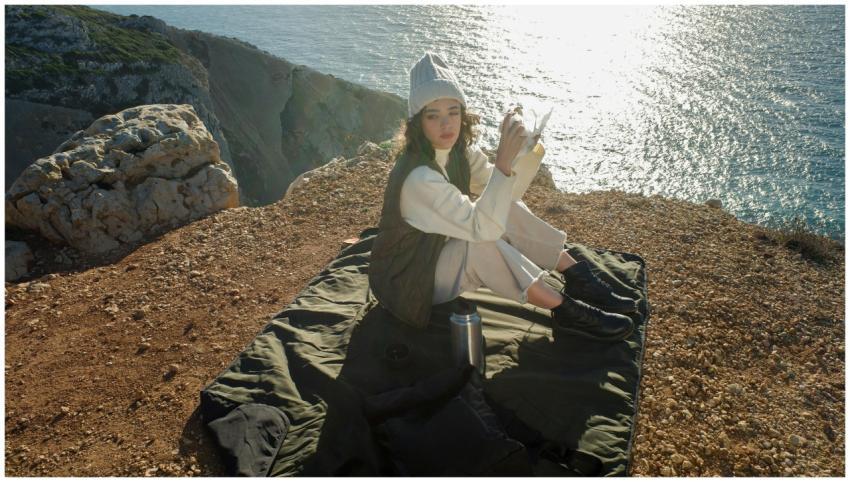 A woman enjoying a relaxing moment on a cliffside