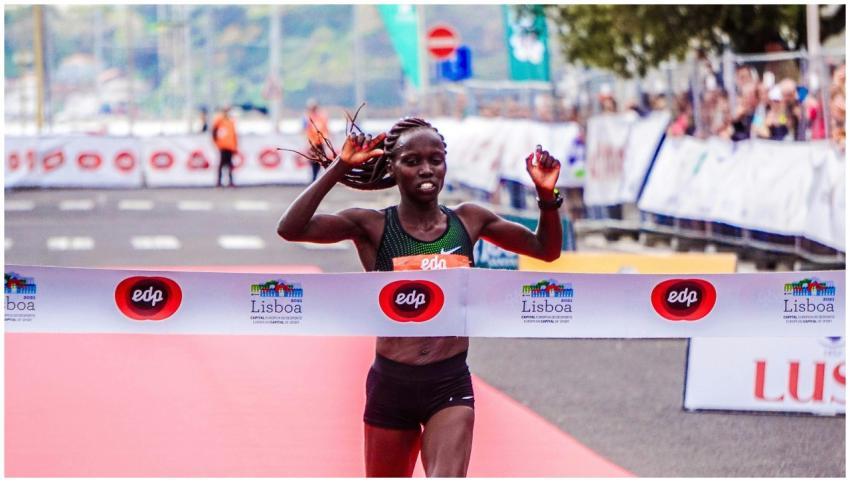 A female athlete triumphantly finishes a marathon