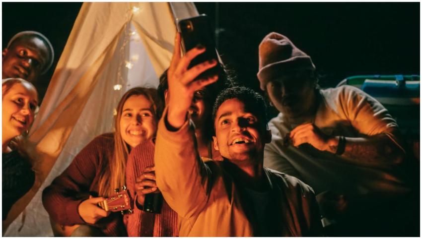 A joyful group of friends takes a selfie together