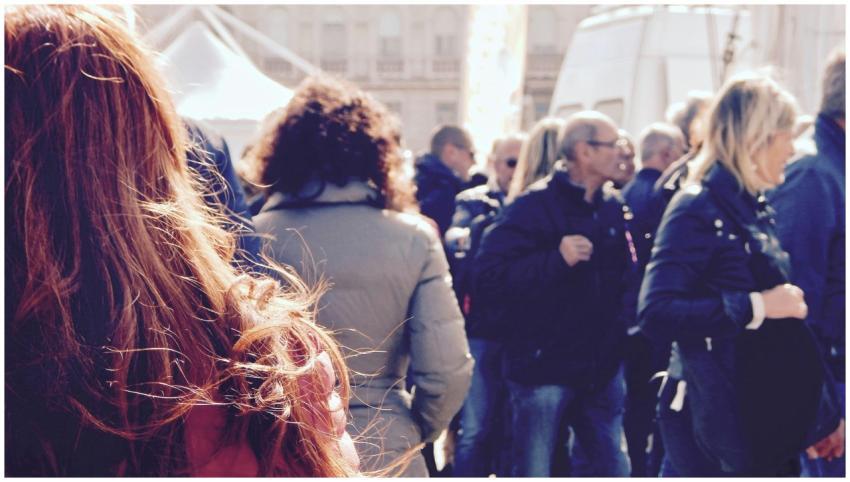 A lively group of people gathers in an outdoor set