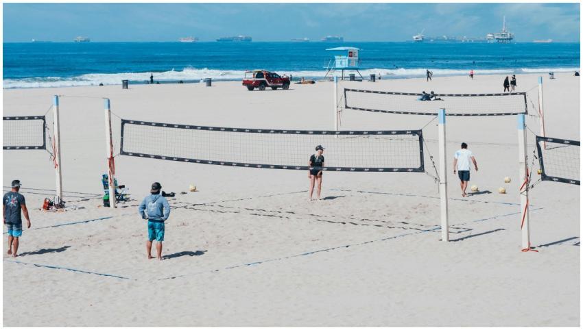 A fun beach volleyball game with players on a sunn