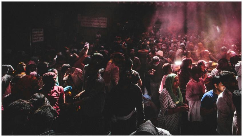 A lively crowd celebrates Holi, the festival of co