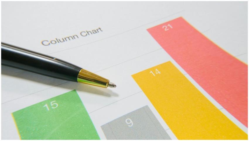 Close-up image of a colorful column chart and pen