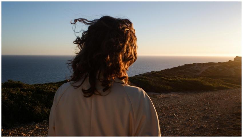 Back view of a person with messy hair overlooking