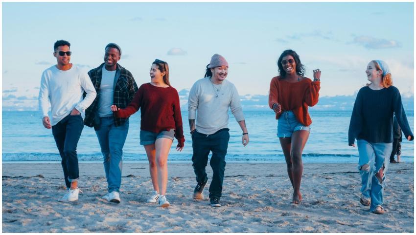 A diverse group of friends happily walking on the