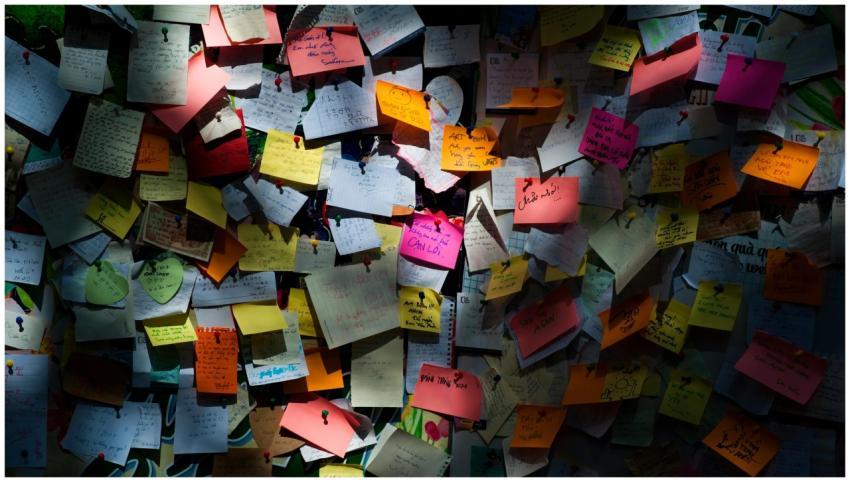 Various colorful sticky notes pinned on a board cr