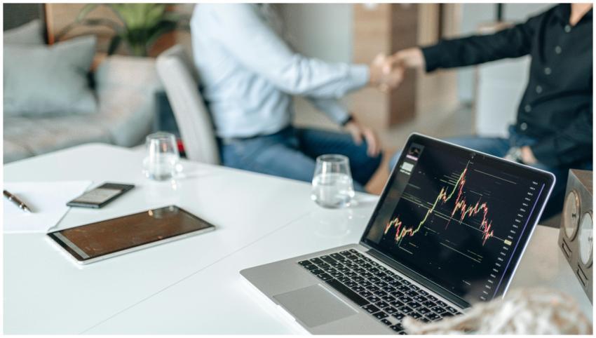 Two professionals shaking hands in an office with