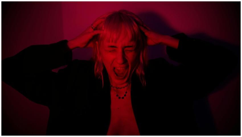 Portrait of a woman expressing strong emotion in d