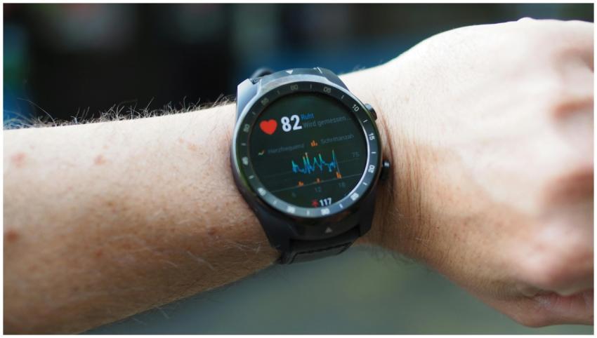Close-up of a smartwatch showing heart rate and da
