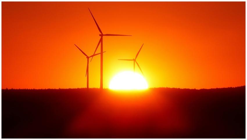 Stunning silhouette of wind turbines against a vib