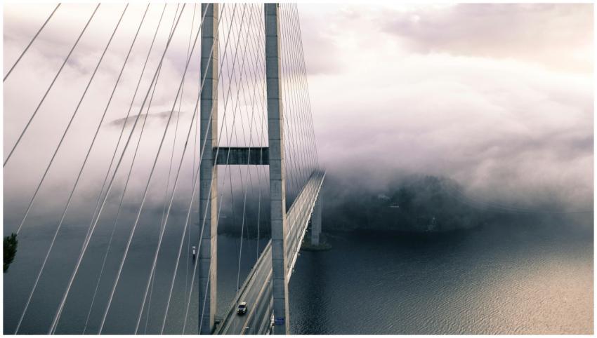 A dramatic view of a fog-covered suspension bridge