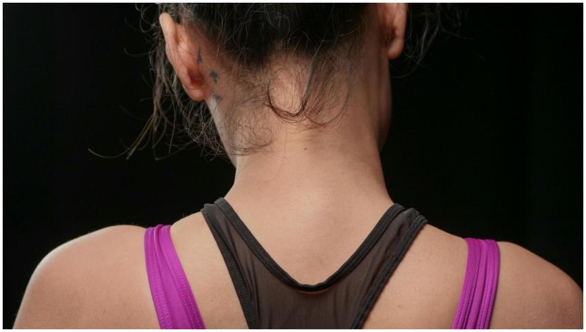 Close-up view of a woman's back wearing a sports t