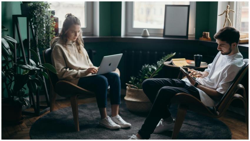 A couple working remotely in a stylish home office