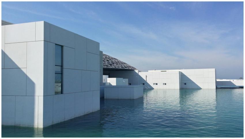 Contemporary building with water reflections and c