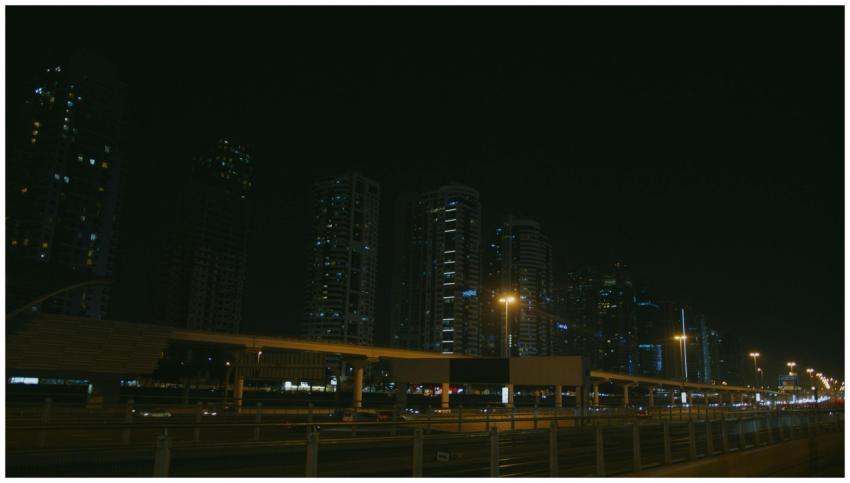Moody cityscape of skyscrapers at night with illum