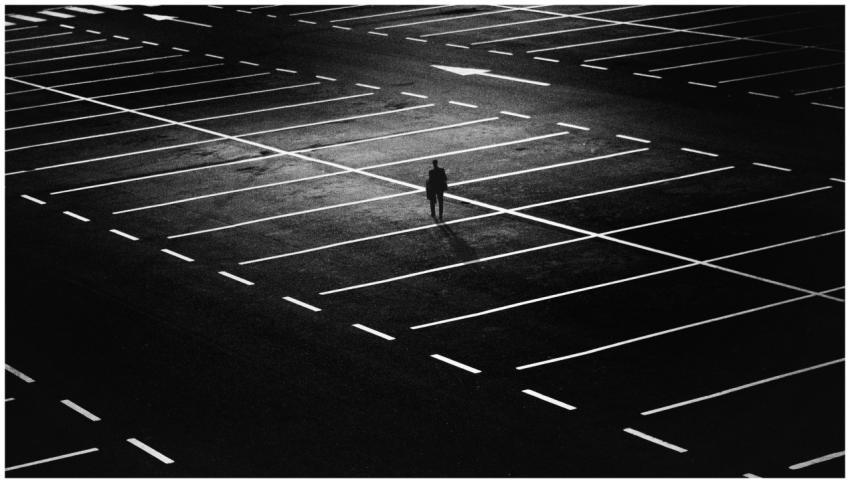 Silhouette of a solitary figure in an expansive ni