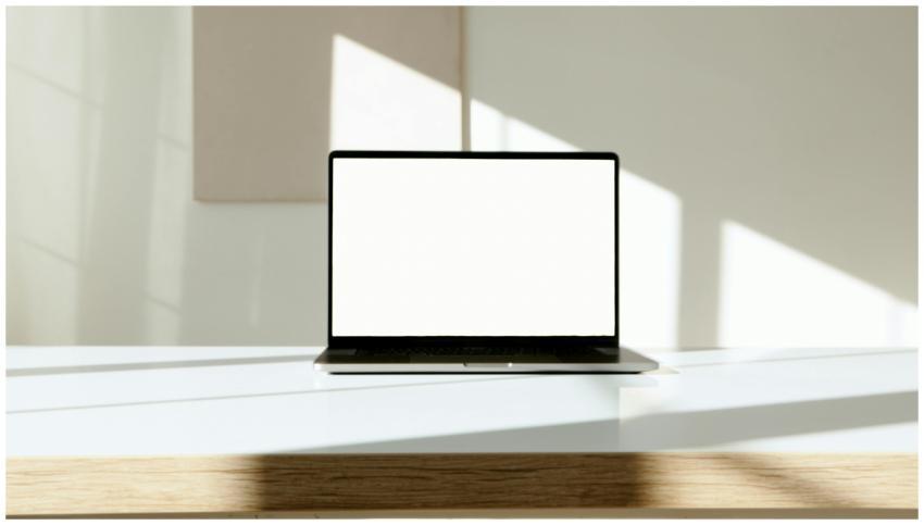 A laptop with a blank screen displayed on a stylis