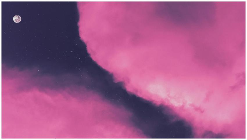 A mesmerizing view of pink clouds with the moon an