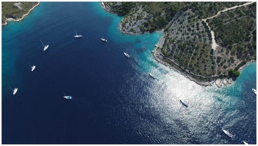A breathtaking aerial view of sailboats anchored n