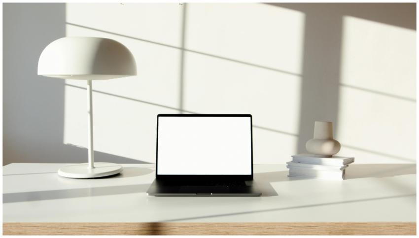 Minimalist desk setup featuring a laptop, stylish