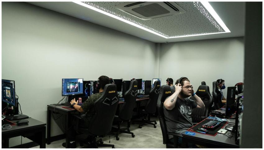 Group of gamers intensely playing video games in a