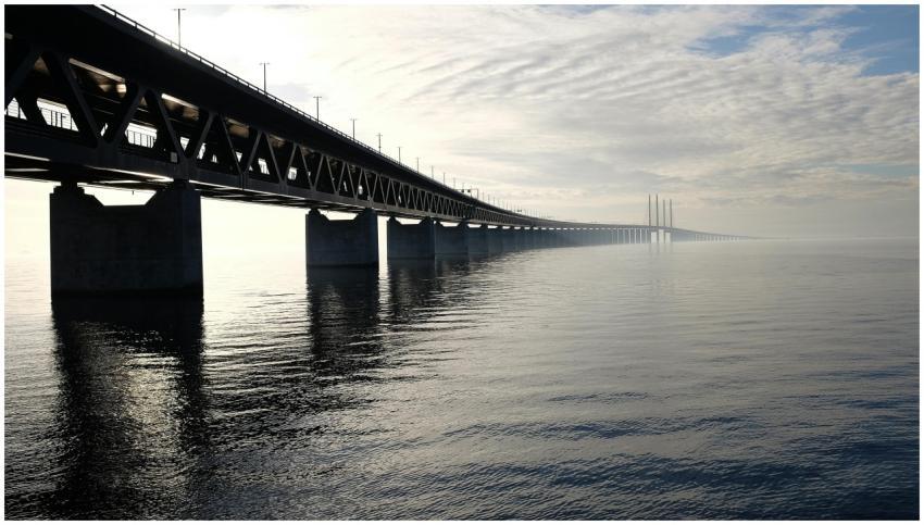 A stunning view of a large steel bridge reflecting