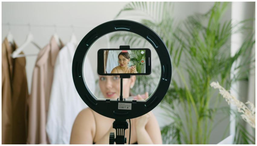 Woman creating video content using smartphone and